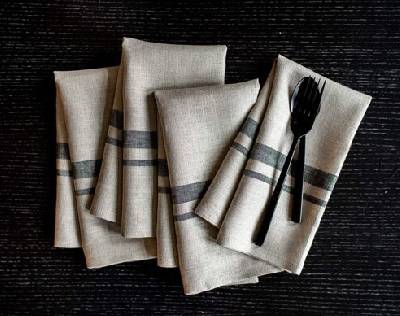 Four table handkerchiefs along with a fork and knife